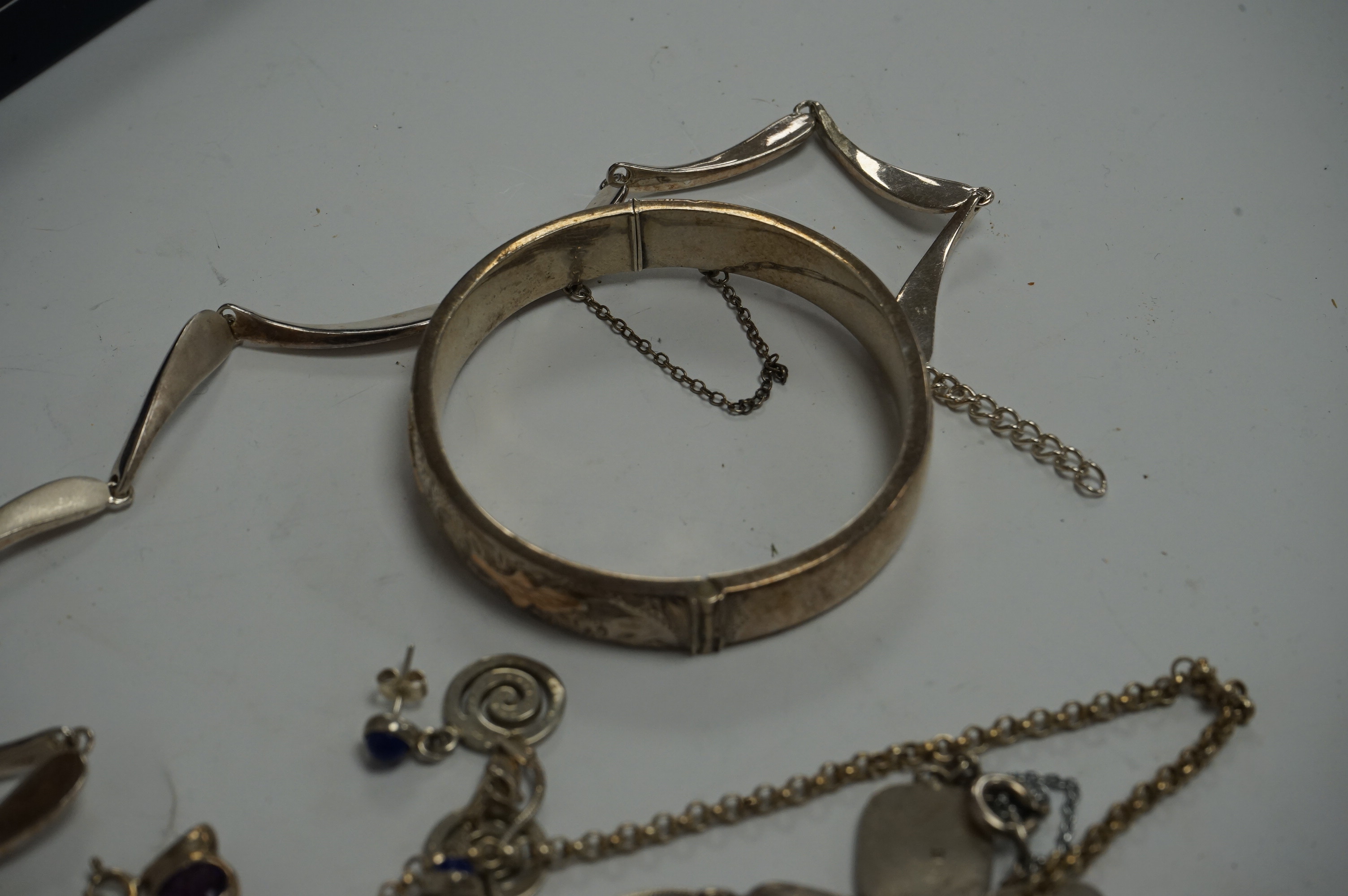 A stylish modern 925 necklace, 42cm, a modern silver bracelet with links decorated with Viking ships and other jewellery including a silver hinged bangle. Condition - fair to good